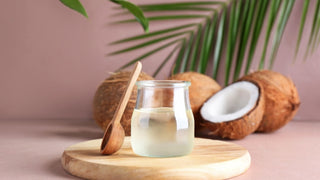 Jar of Coconut Oil and Spoon on Color Background