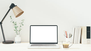 Workspace with blank screen laptop computer