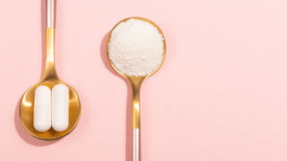 Hydrolyzed collagen supplement powder and capsule in gold spoon on pink background