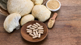 Mushroom powder and capsule supplements on wooden surface