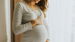 Pregnant woman holding stomach