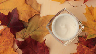 Skincare cream in fall autumn leaves