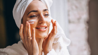 Woman applying topical fish collagen cream