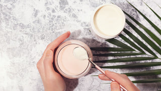 Woman hands, collagen powder and smoothie.