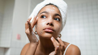 Woman washing face with cleanser