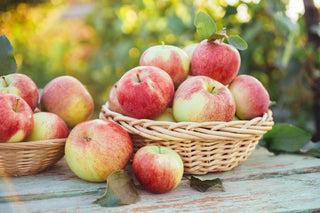 A basket of apples on a wooden table