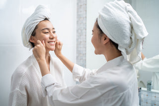 woman friend touches on face and apply cream lotion together after shower