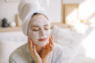 Young woman making face mask in the morning at home.