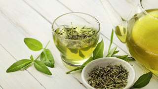 tea cup glass with green tea leaves